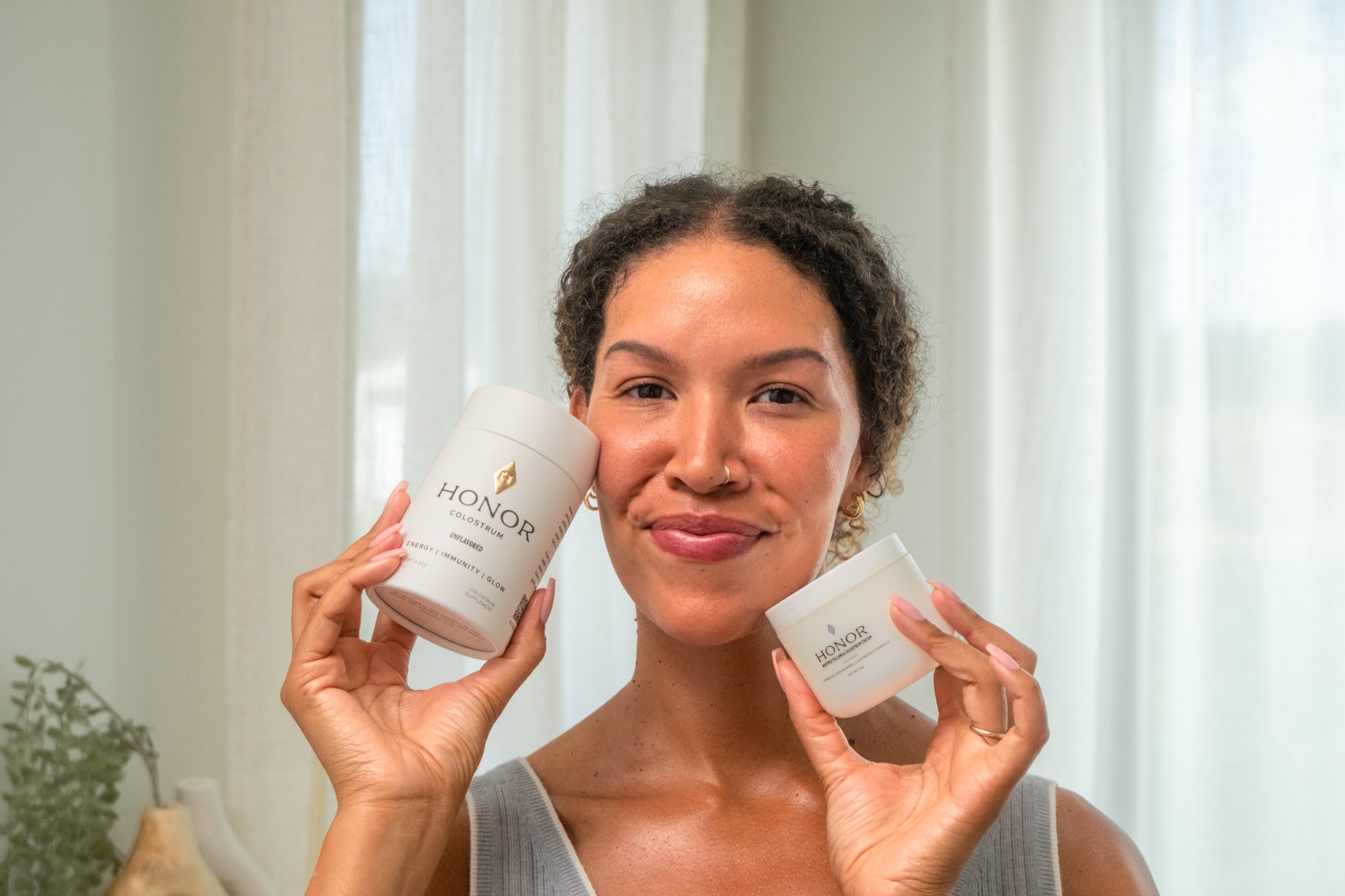 Honor customer holding the colostrum tube and the whipped tallow jar